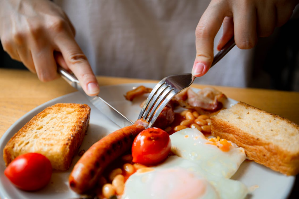 High protein breakfast search trend shown by eggs, sausage, beans, and toast on a plate