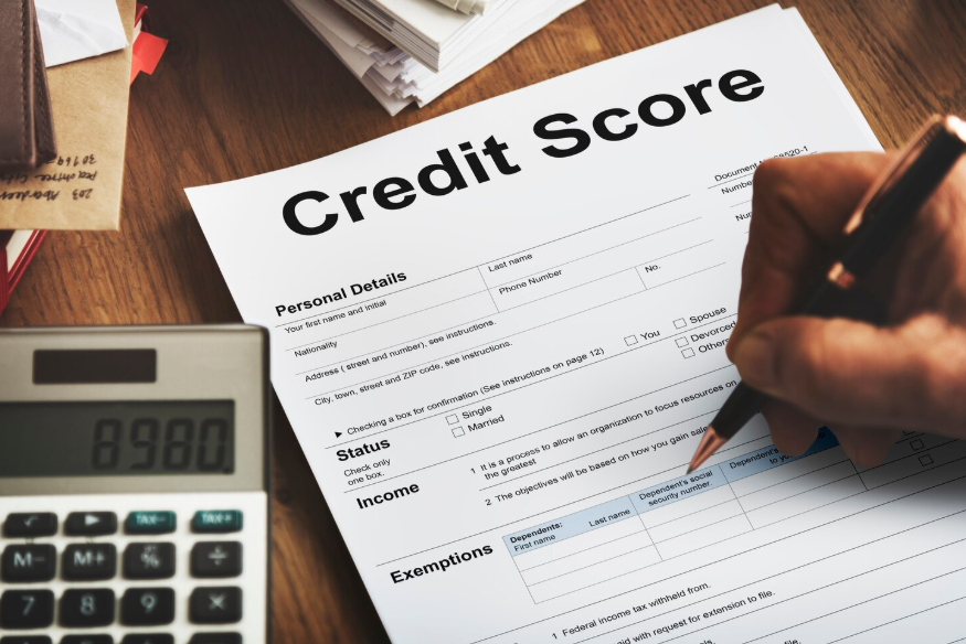 Paperwork and calculator shown while researching how to raise credit score fast