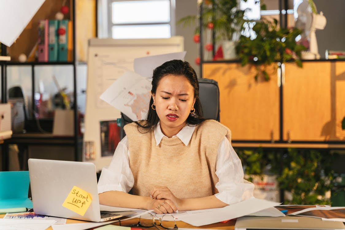 Person feeling stuck at a desk while searching how to be motivated during a work slump